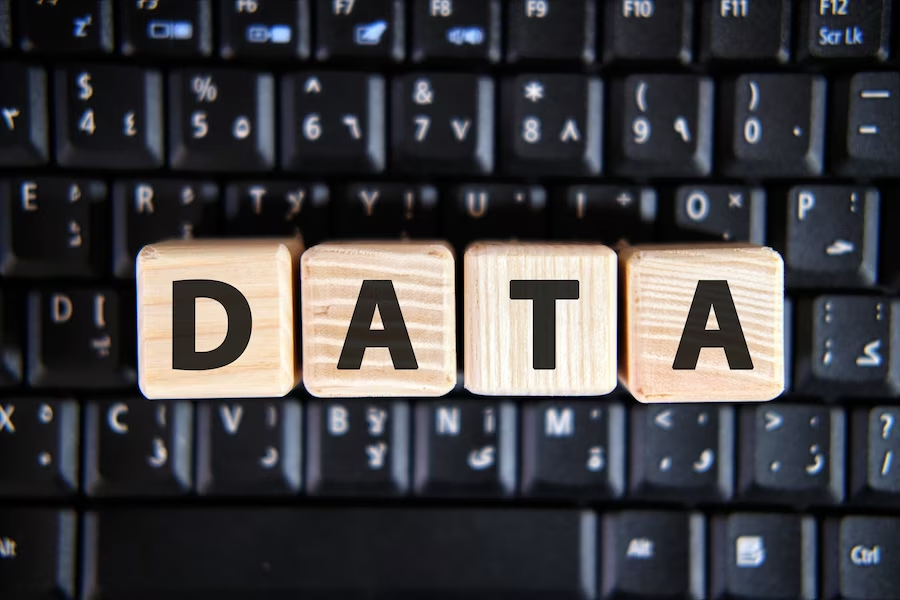 "Data" spelled out with wooden cubes atop a keyboard